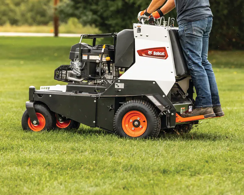 Bobcat AE30S stand-on aerator working a lawn