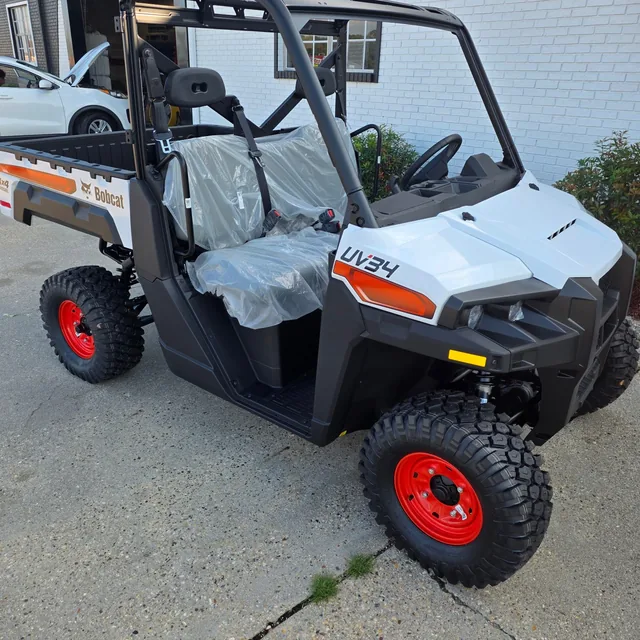 Front quarter view of a Bobcat UV34 showing the bench seats and cargo box on the lot at Dykes Motors, Collins, Mississippi