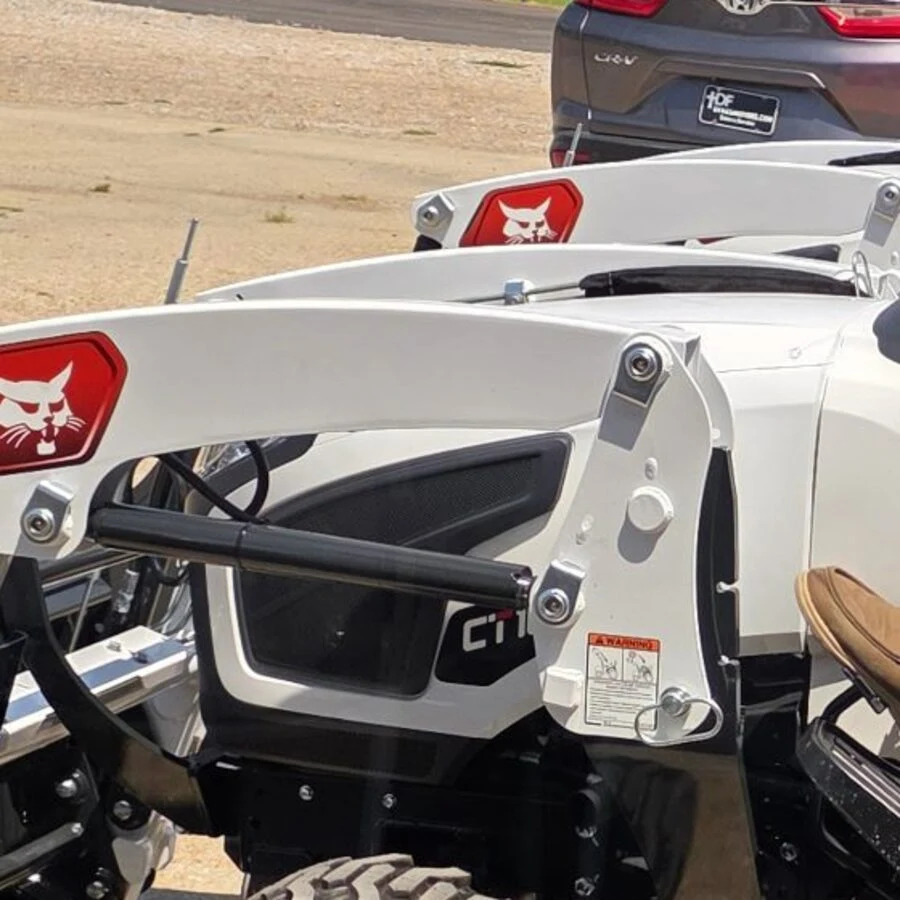 Front loader arms and Bobcat badge on a pair of CT-series sub-compact tractors on the lot at Dykes Motors in Collins, Mississippi