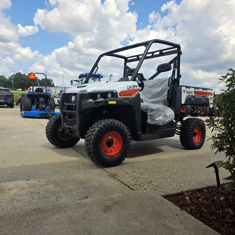 The new Bobcat UV34 4x4 diesel utility vehicle parked on the lot with new LS tractors and another UV34 behind it