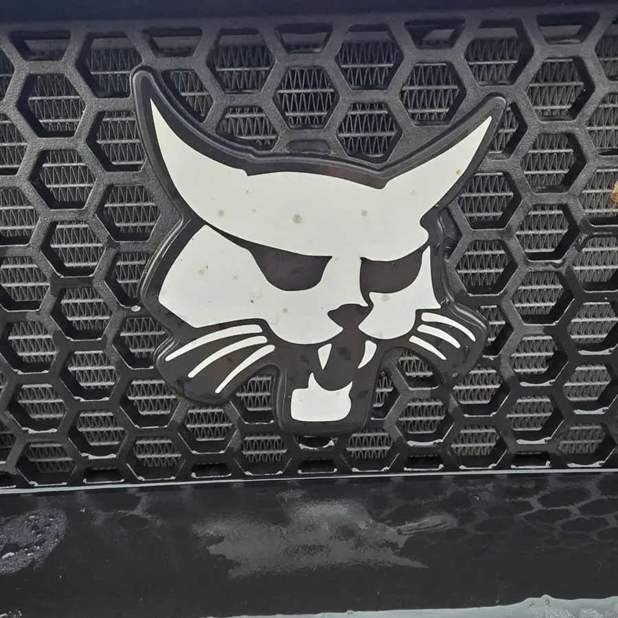 Close-up of the Bobcat lynx badge on the UV34 front grille