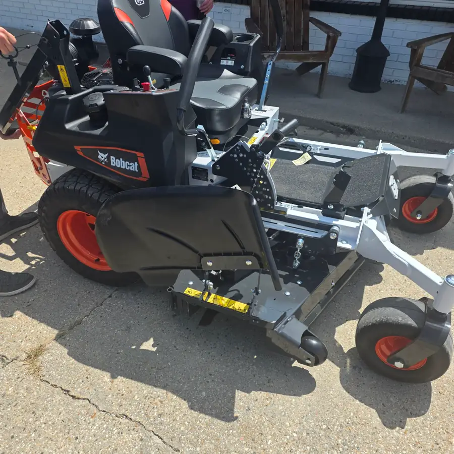 Bobcat ZT zero-turn mower with its cutting deck, parked in front of the Dykes Motors store in Collins, Mississippi