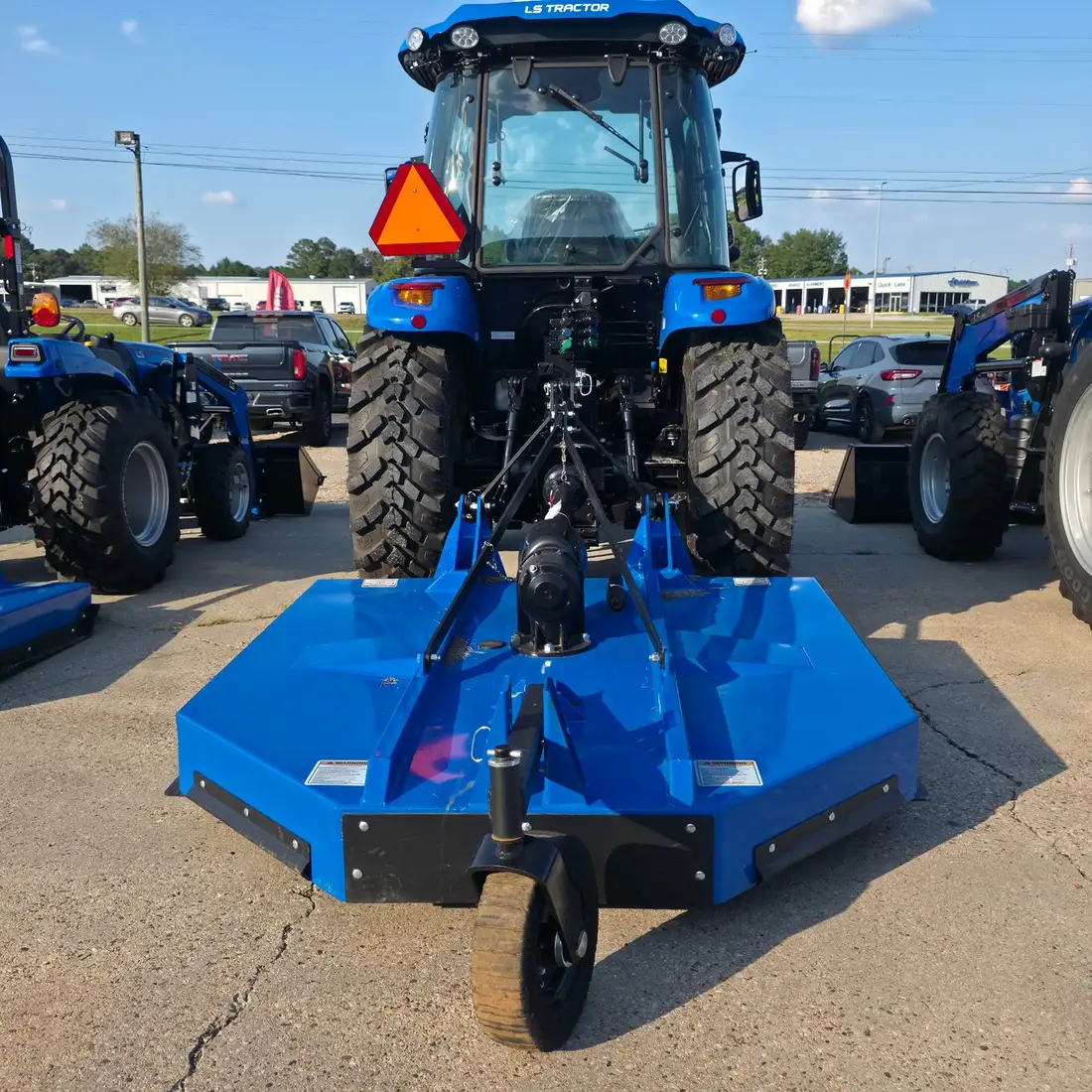 LS slip-clutch rotary cutter, front-mount angle, hitched behind an LS tractor on the lot at Dykes Motors, Collins, Mississippi