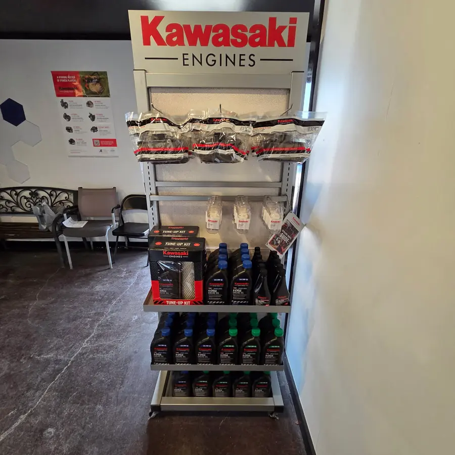 Genuine Kawasaki Engines air filters, oil filters, spark plugs, engine oil, and tune-up kits on display at the Dykes Motors Collins parts counter