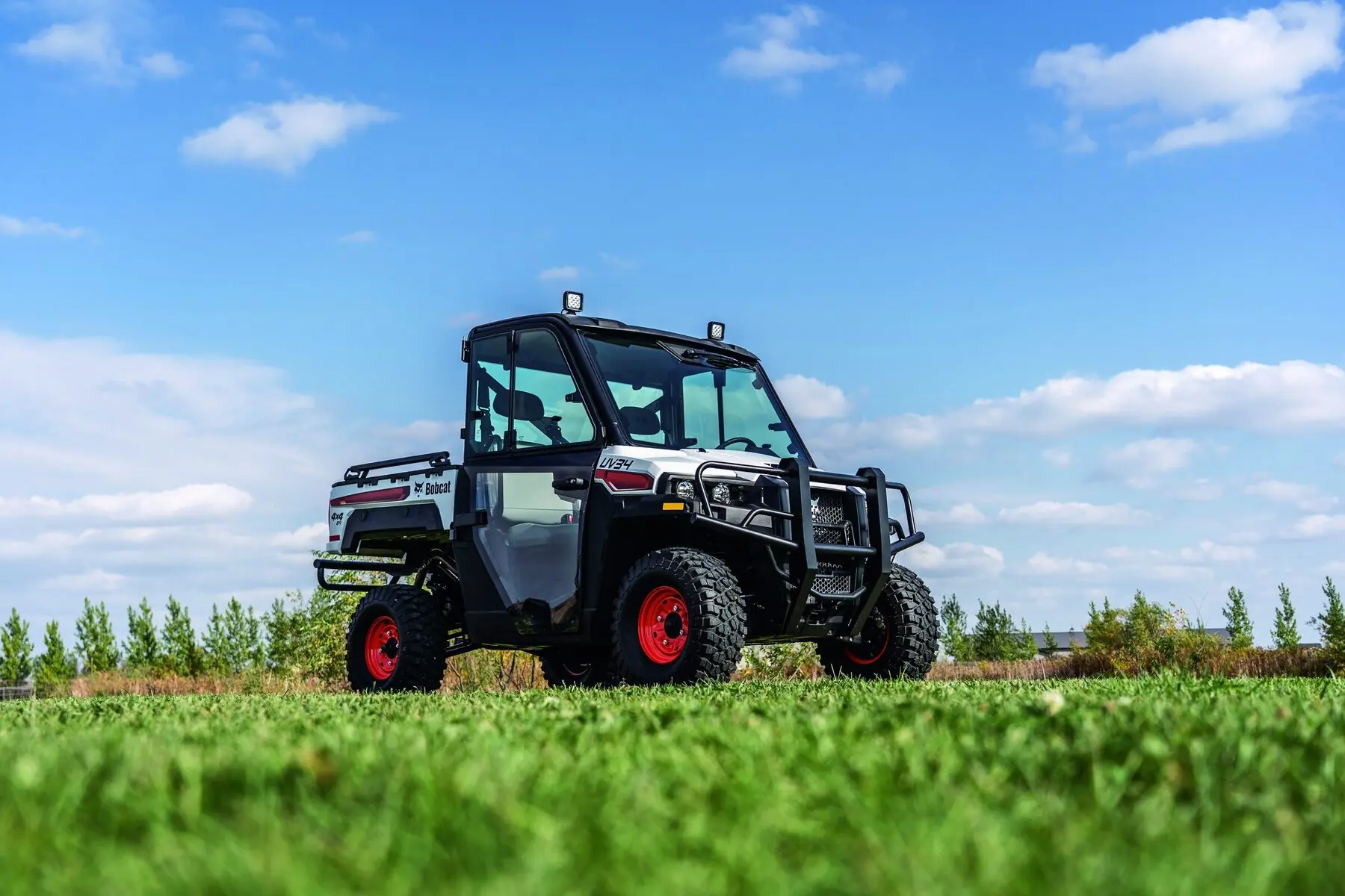 Bobcat utility vehicle in a field at dusk